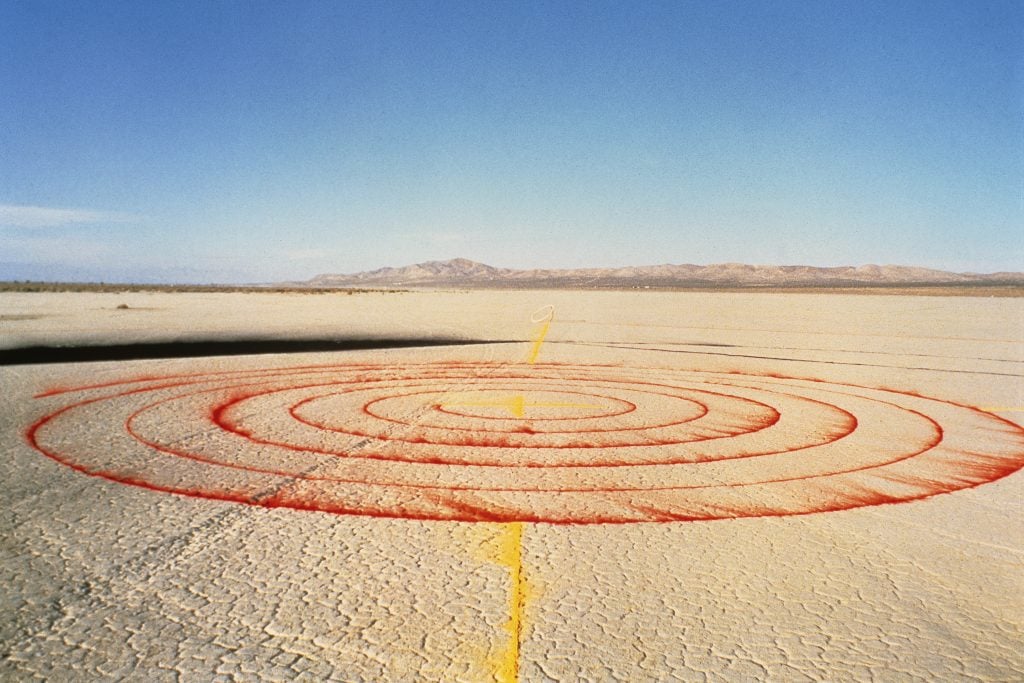 a red spiral of pigment on the desert earth