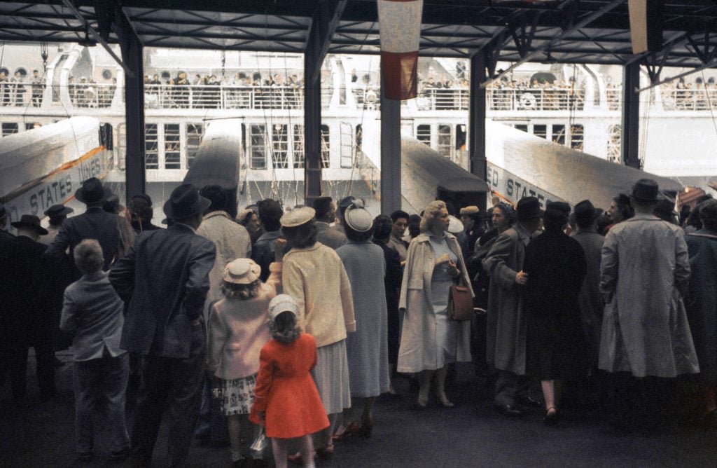 Passengers wait to embark on the SS United States, a luxury liner for the United States Lines, built as the fastest ocean liner to cross the Atlantic in New York, New York.