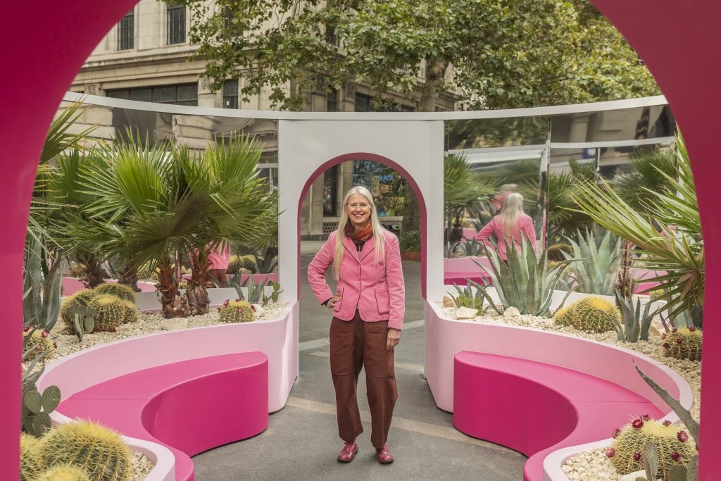 Designer Nina Tolstrup inside a pink, mirrored, open air courtyard art installation