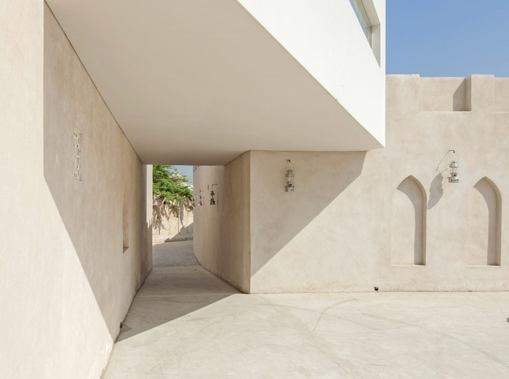 a pale architectural building in Sharjah, against a blue sky