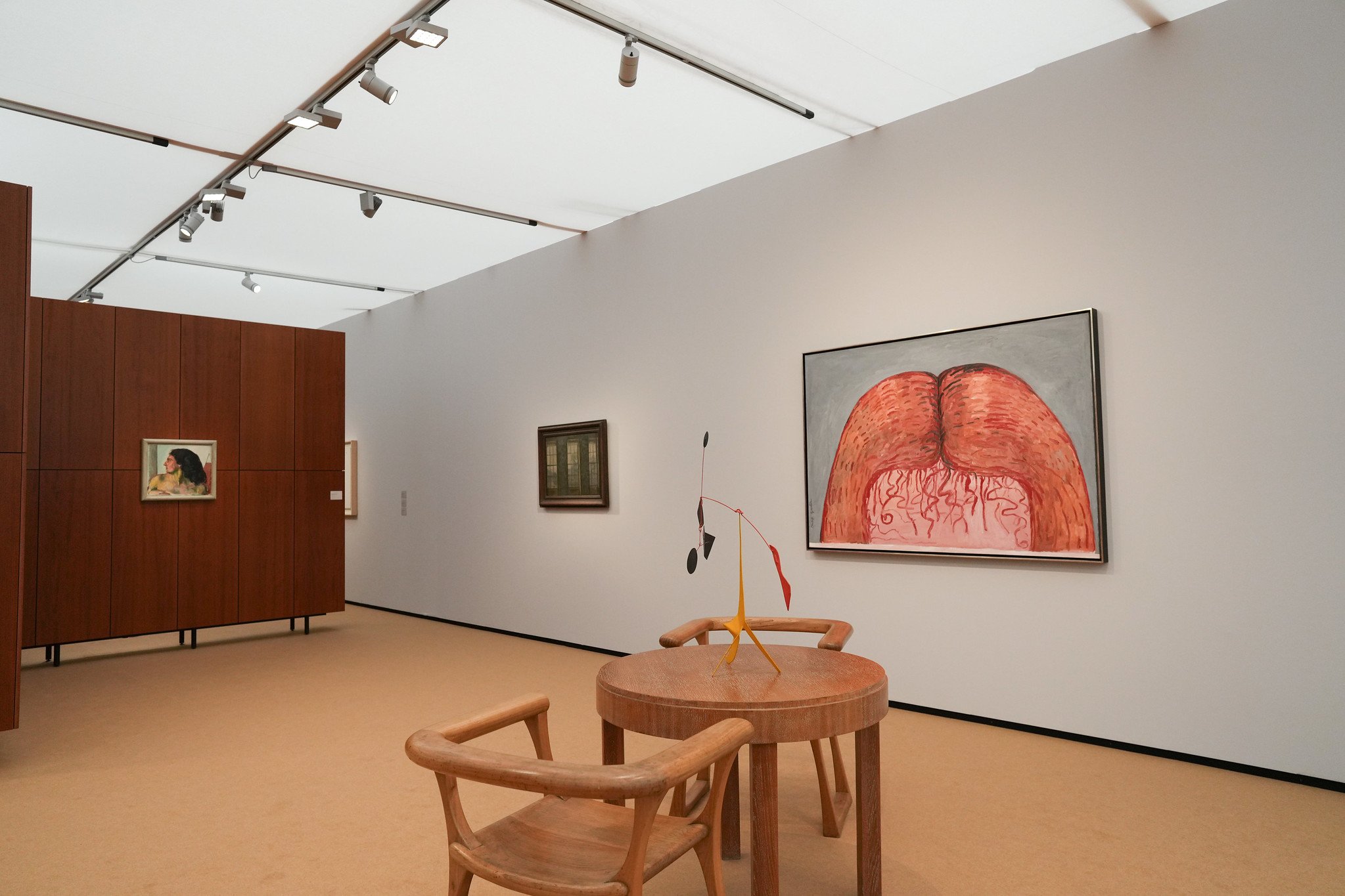 A booth holds a number of paintings and sculptures