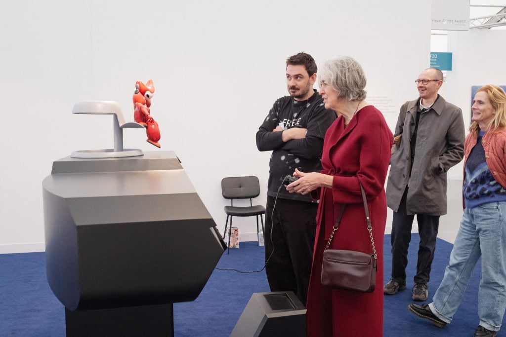 Visitors engaging with a video game in a tech-driven art installation.