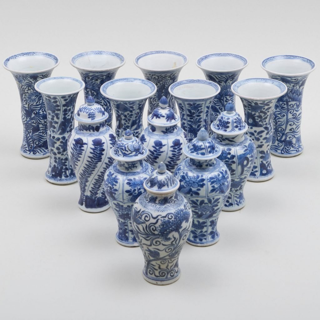 a group of blue and white vases arranged in triangular pattern