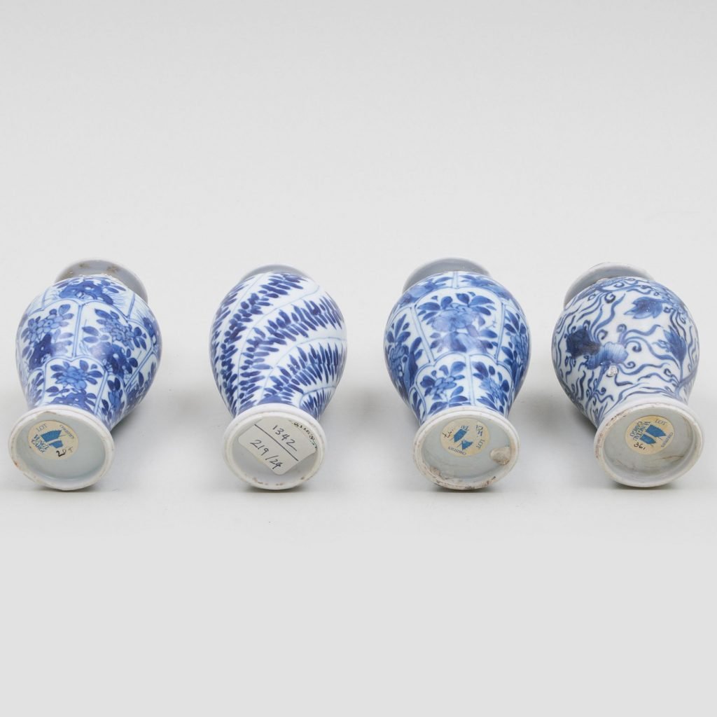 blue and white vases lying on a white surface