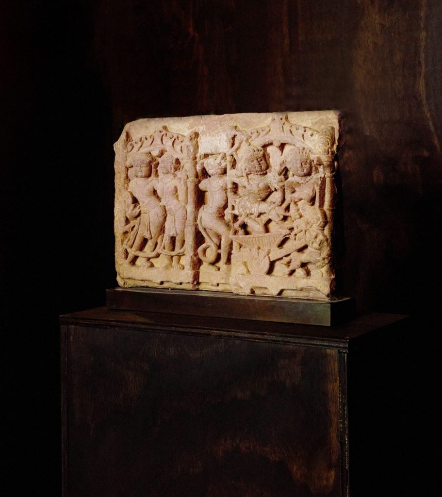 an ancient relief deceits a scene of deities 