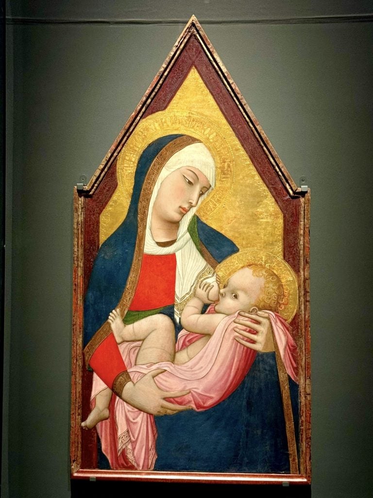 a painting of a woman breastfeeding a child