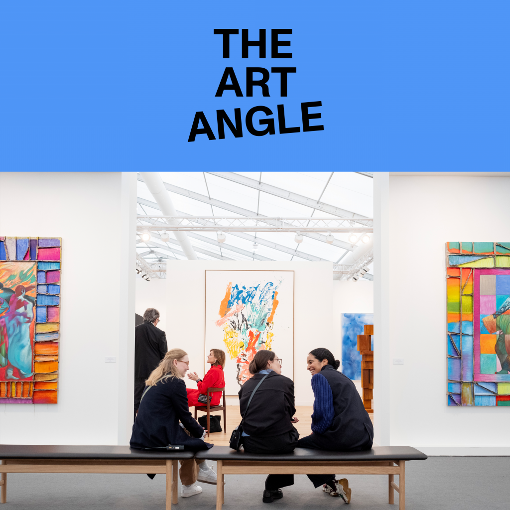 three women sit on a bench in an art fair surrounded by colorful abstract paintings