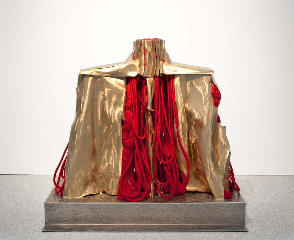 Barbara Chase-Riboud's red and gold sculpture 'Mao's Organ' against white gallery backdrop