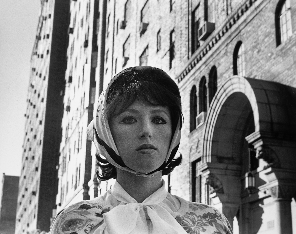 black and white photo of a woman and a building