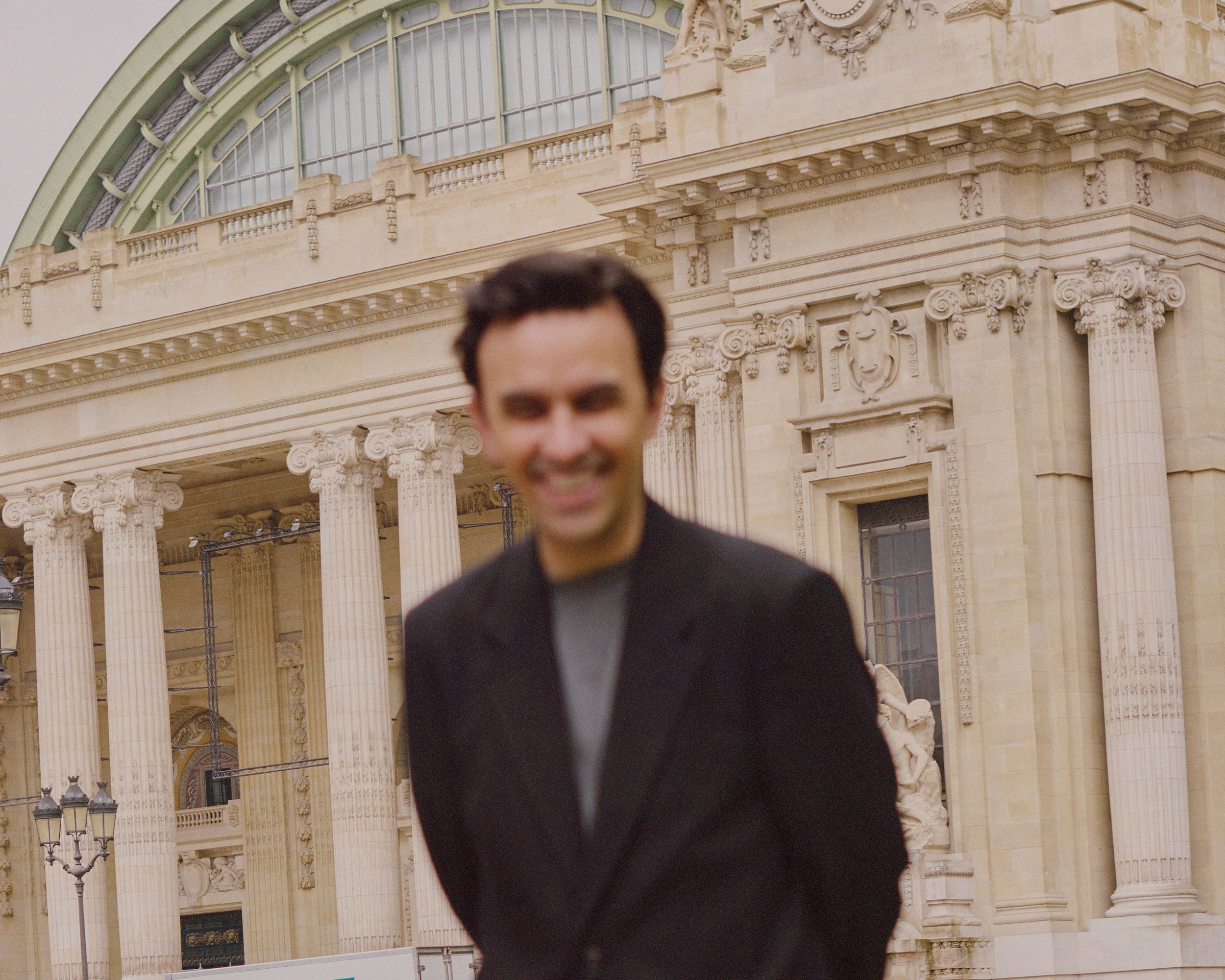 Blurred man standing before a neoclassical building