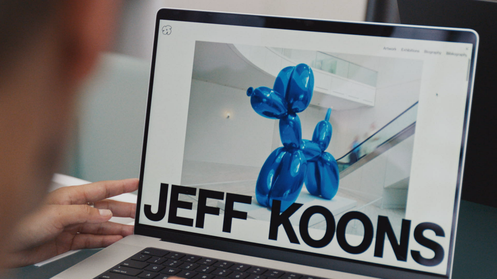 a computer screen with the word Jeff Koons written and a blue balloon dog in background