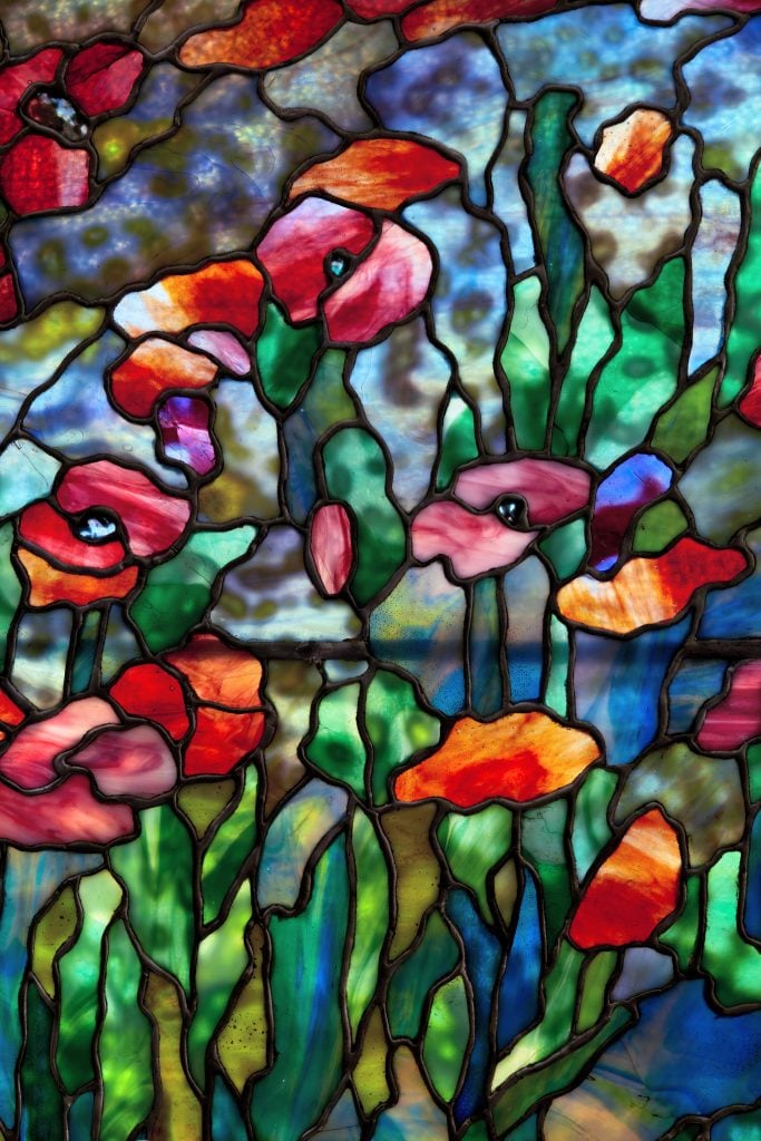 close up detail from the stained glass showing poppies