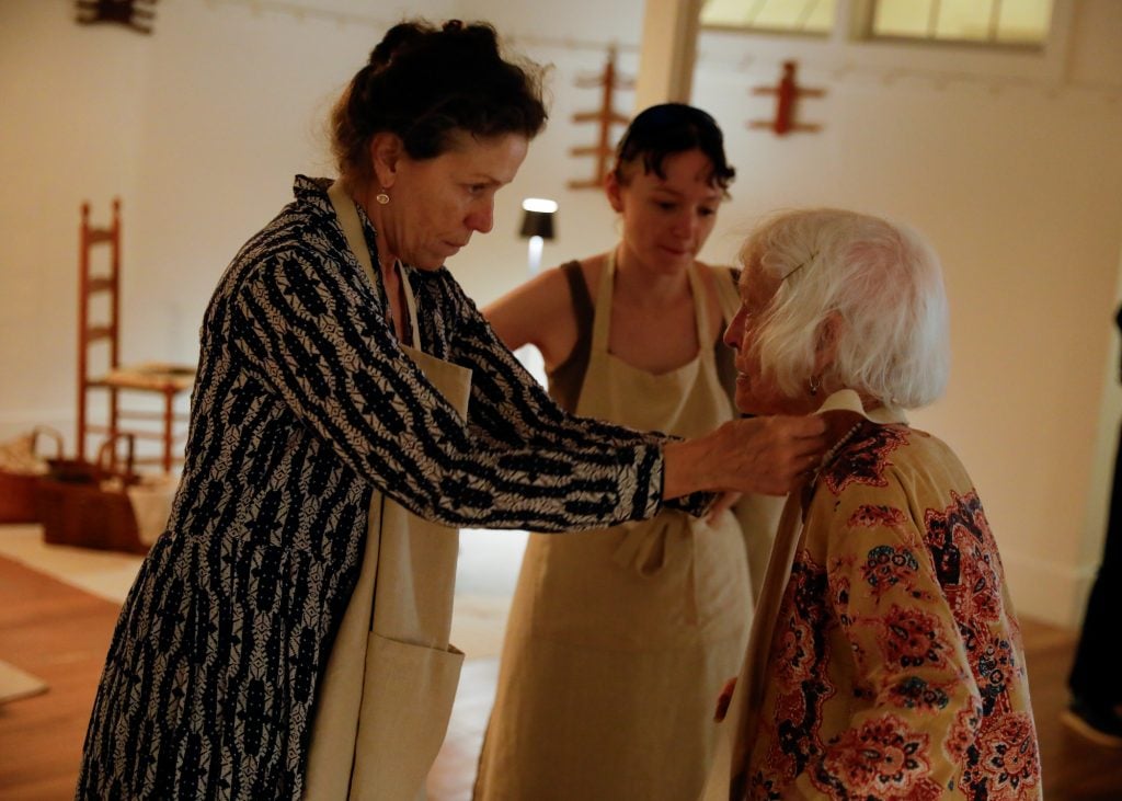 Frances McDormand fixing Joan Jonas collar on opening night of Cradled show