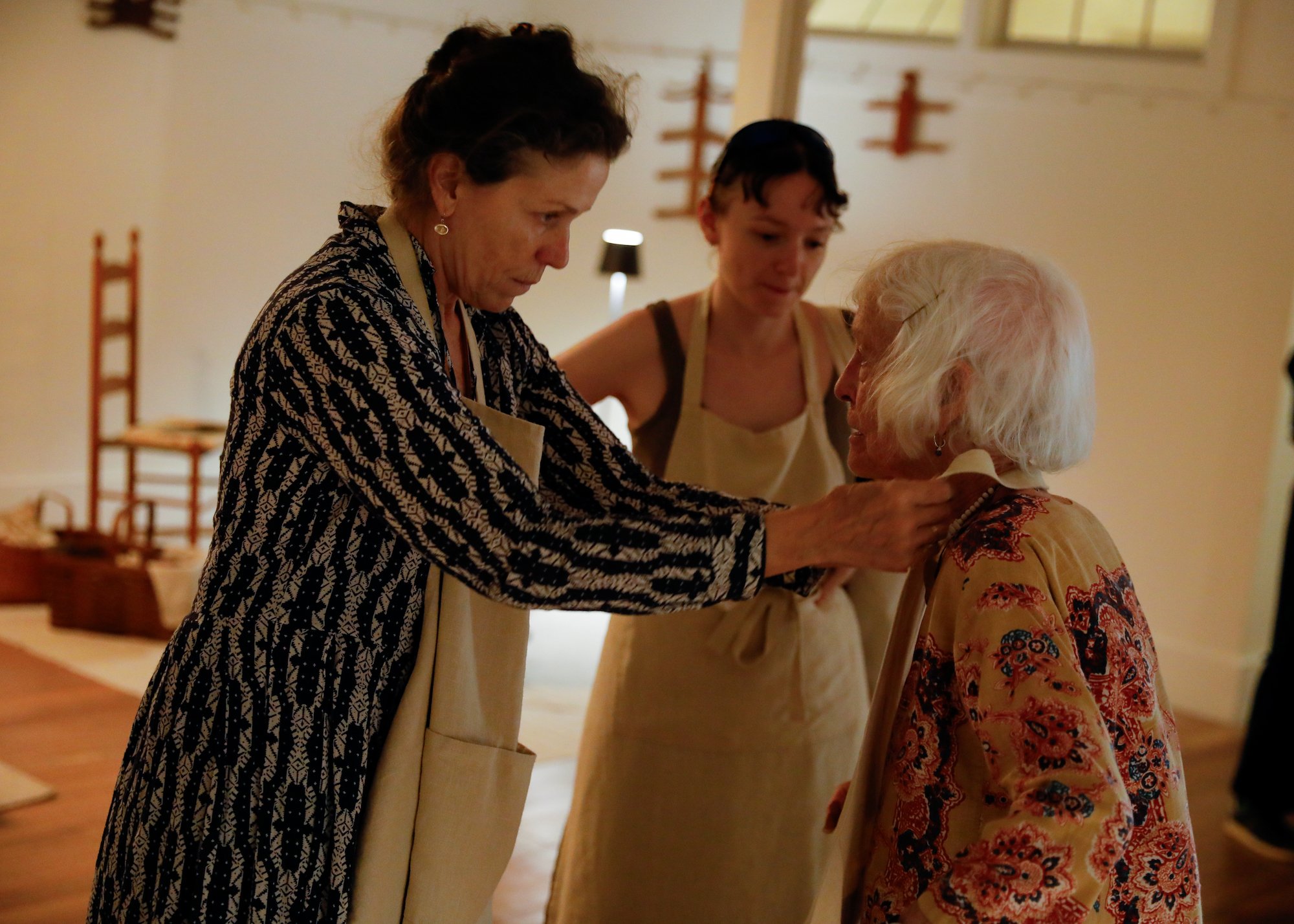 Frances McDormand fixing Joan Jonas collar on opening night of Cradled show