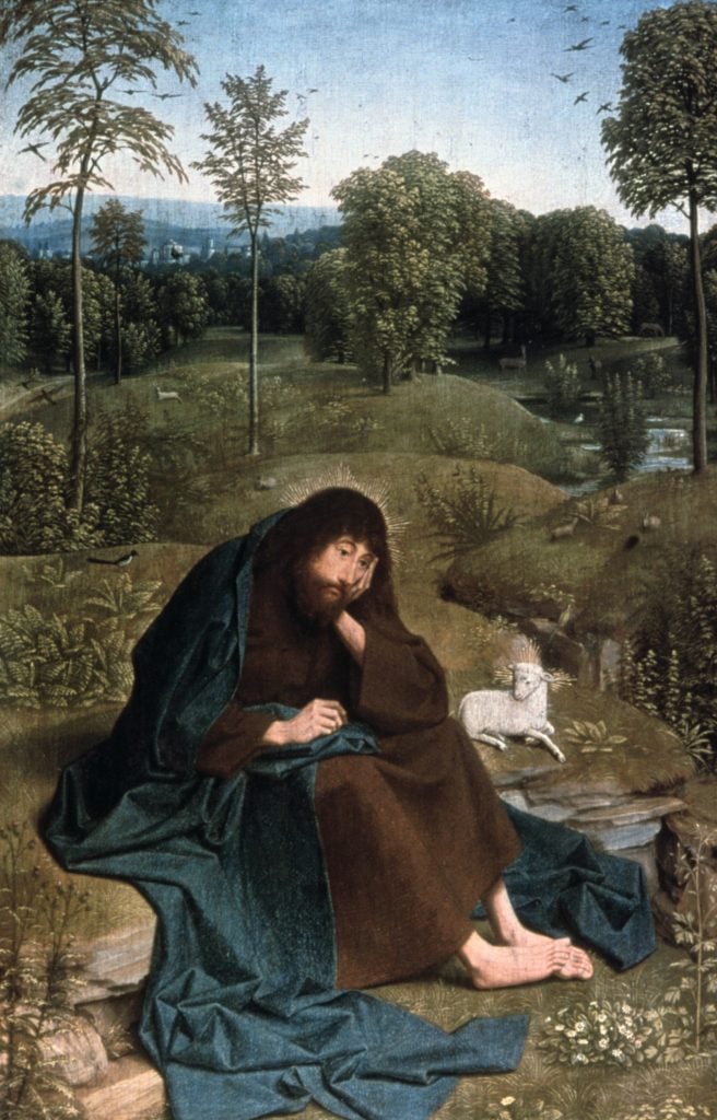 A bearded man draped in a brown robe sits pensively on the ground in a lush, serene landscape, with a lamb resting beside him and distant trees and hills in the background