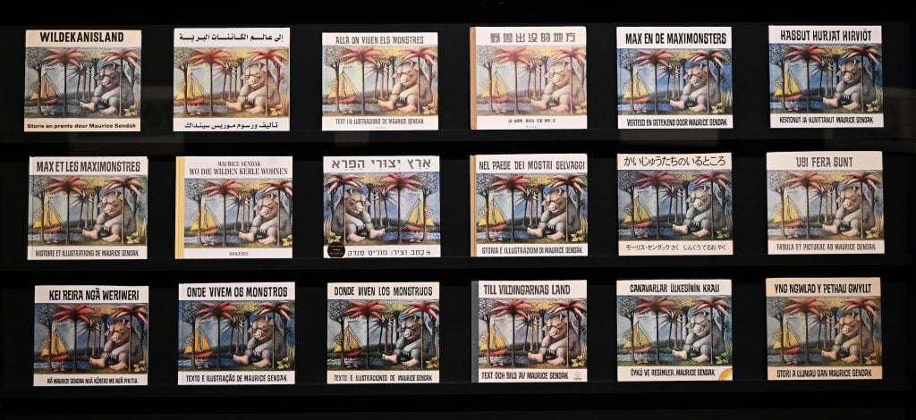 Images of 'Where the Wild Things Are' book covers printed in different languages from around the world are on display