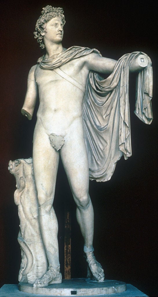 a marble statue of a naked man without forearms