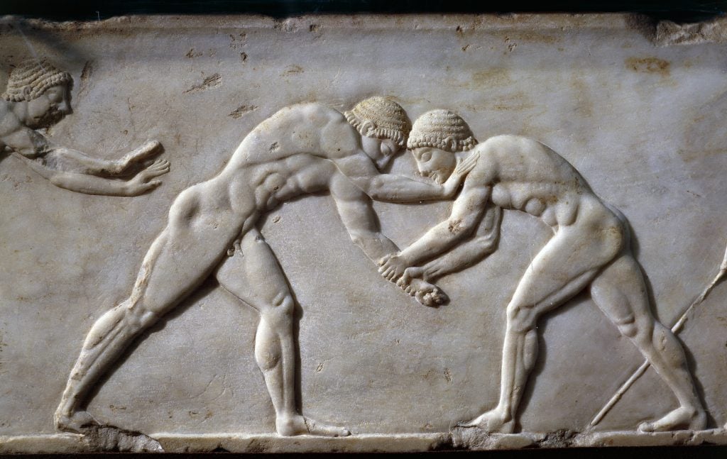 a marble slab with engravings of ancient wrestlers