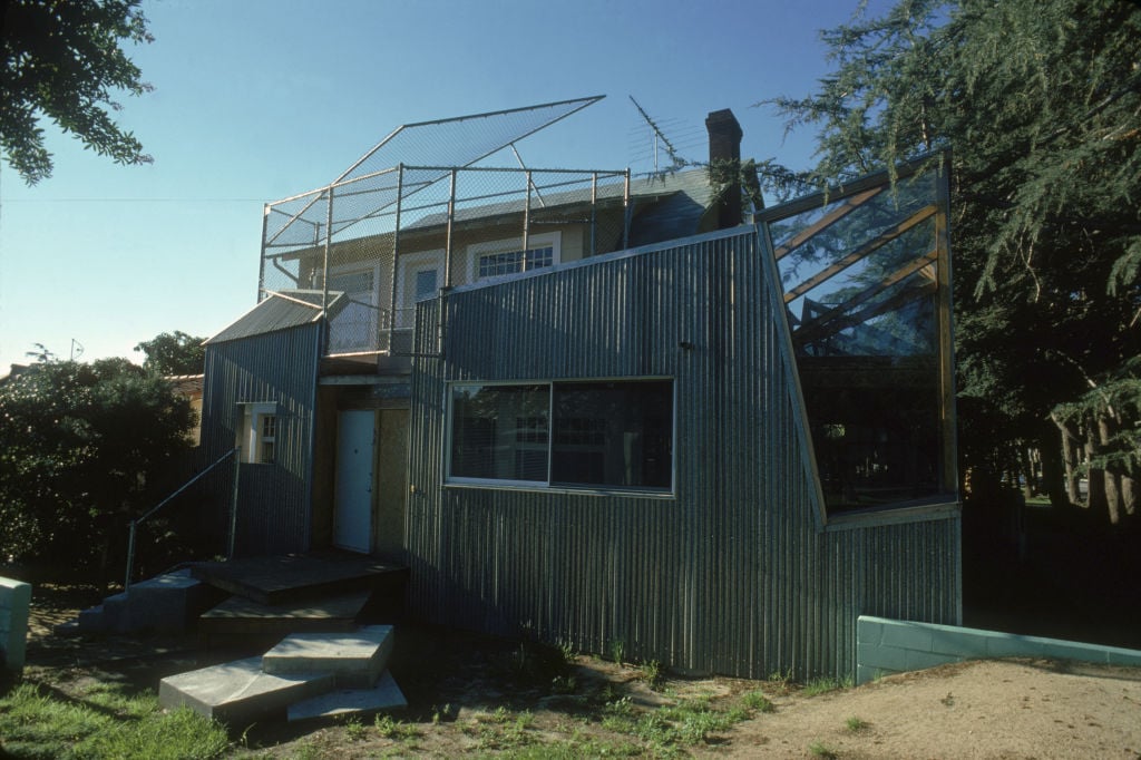 a house with trees and plants in the yard