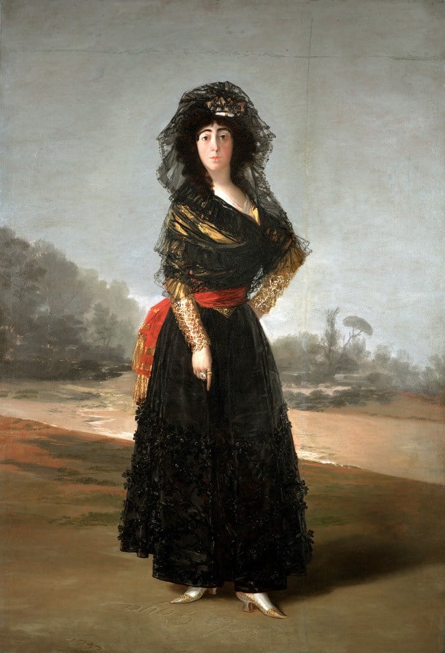 a painting of a woman standing in a black veil and black lace dress with a red sash at her waister. she points at the ground beneath her