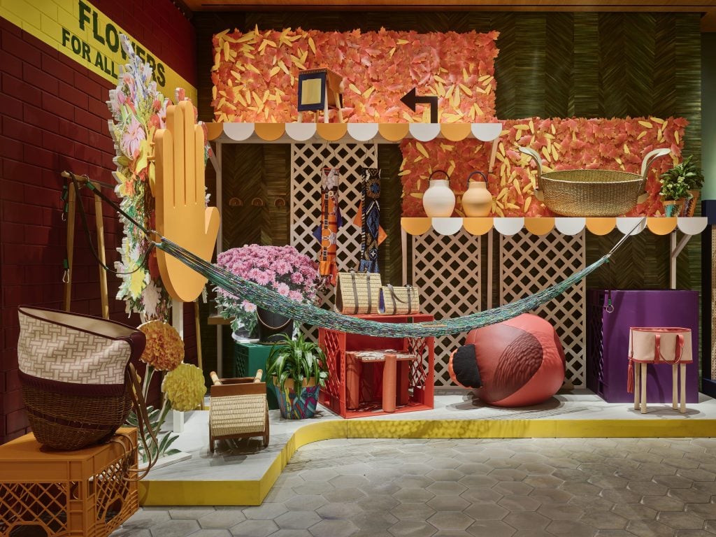 the interior of a store has a bag, a hammock, and various colorful luxury items 