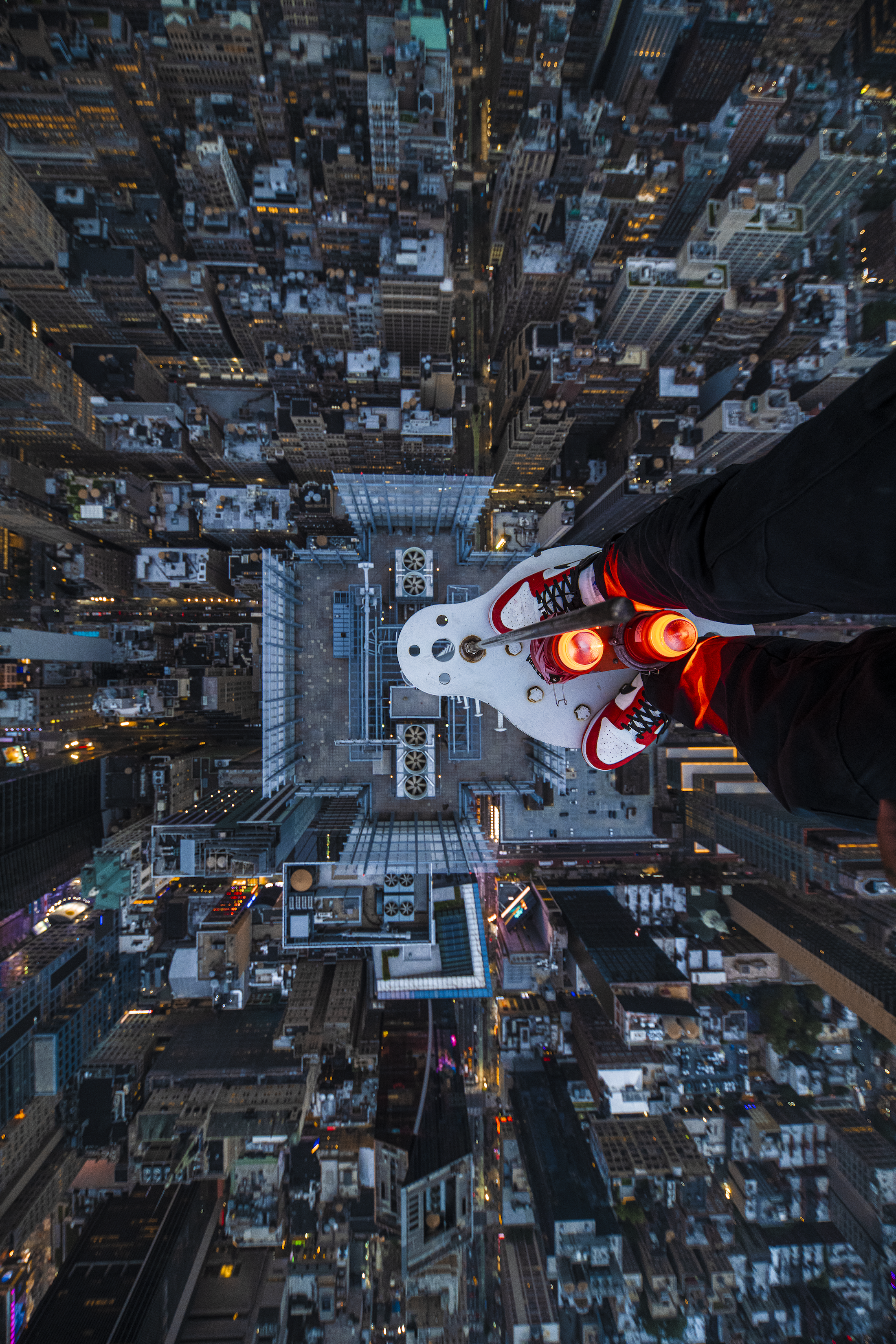 Isaac "Driftershoots" Wright's photograph atop the New York Times Tower. He shot his legs and feet atop the precipice of the building, looking down at the city streets far below.