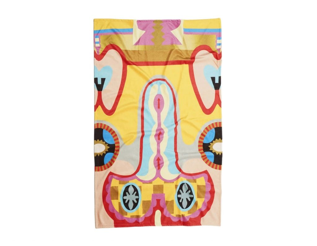 Judy Chicago beach towel decorated in a yellow, pink and blue design with vaguely sexualized forms.