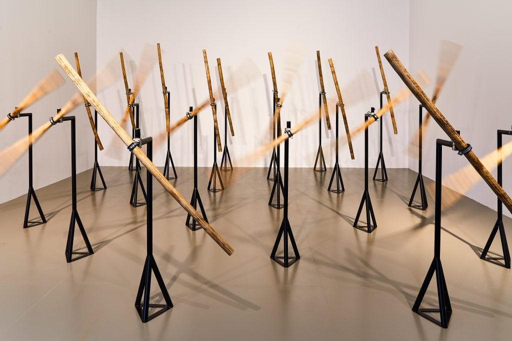 a battery of rainsticks attached to minipods spin like wind turbines in an untitled illustration by Kader Attia 