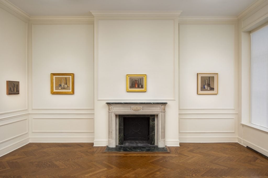 view of an exhibition in a stately house with small paintings