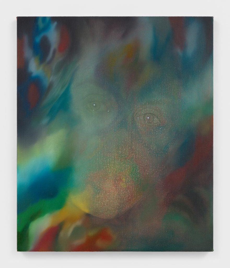 a woman's face is faintly visible behind almost psychedelic colors