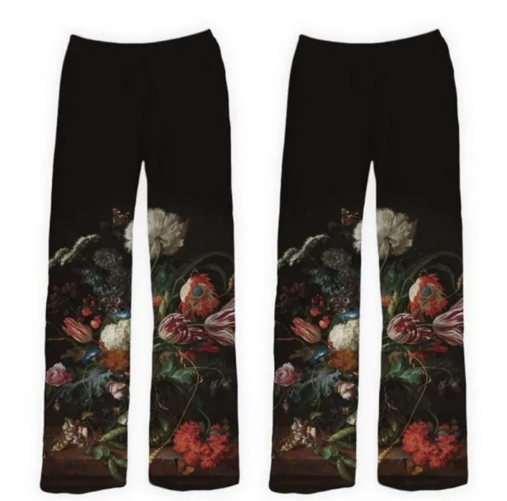 Black pajama pants with a vibrant floral design inspired by a classic still-life painting, featuring detailed flowers such as tulips, roses, and carnations against a dark background