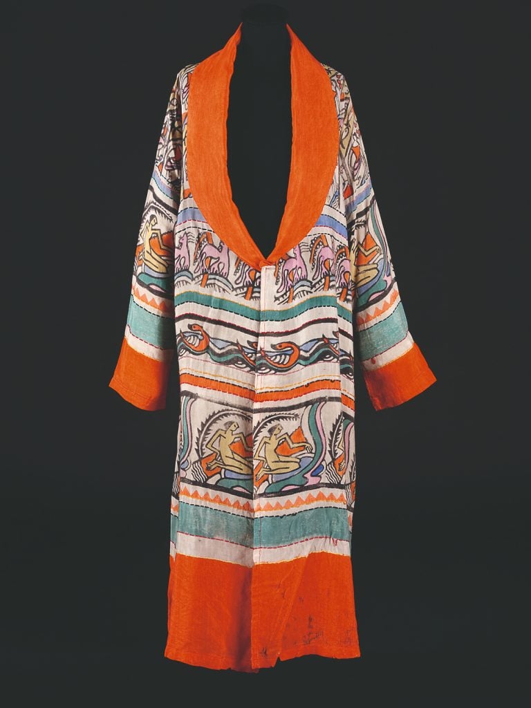 a hanging silk robe covered in a colorful pattern in shades of orange, turquoise and purple