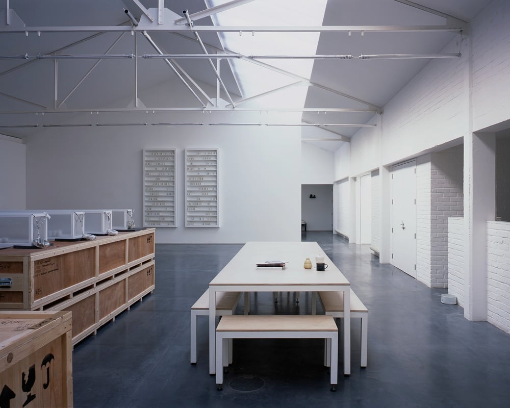 an image of the studio with a white table and walls and wooden crates