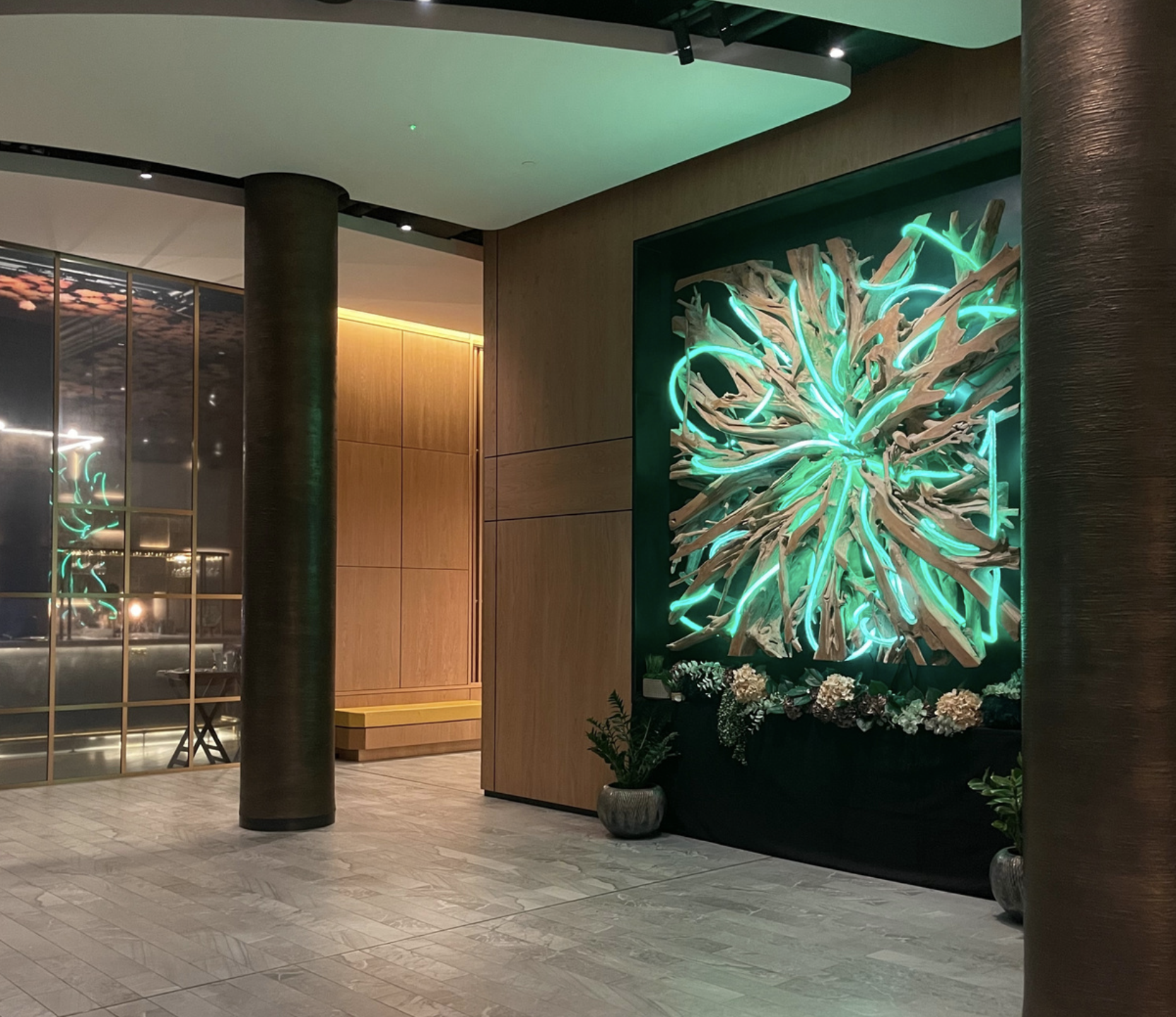 A neon sculpture hangs the wall of a lobby