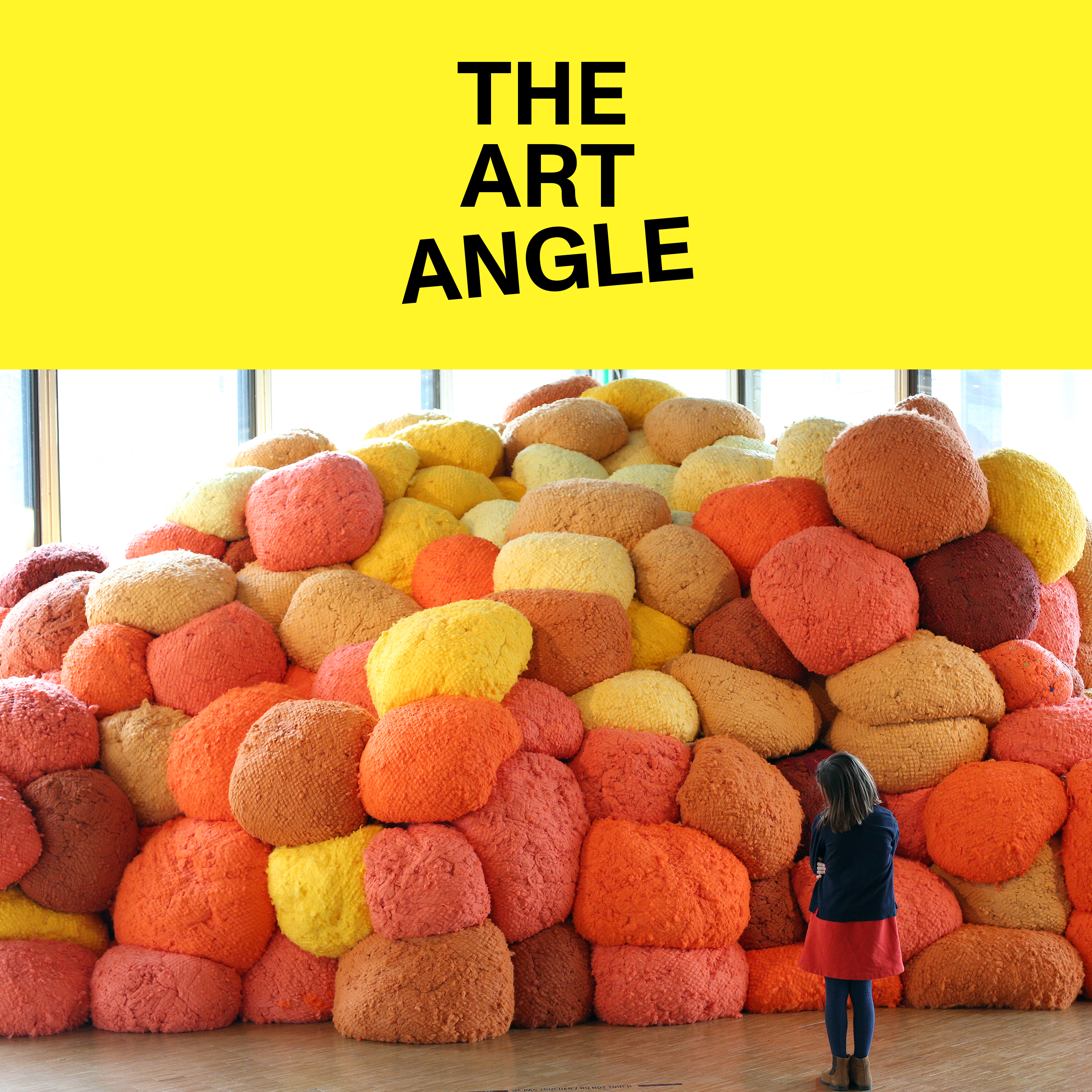 a pile of orange, red, yellow, and brown circular masses comprises a contemporary art installation