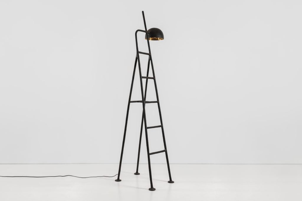 a ladder is plugged in and has an attached light 