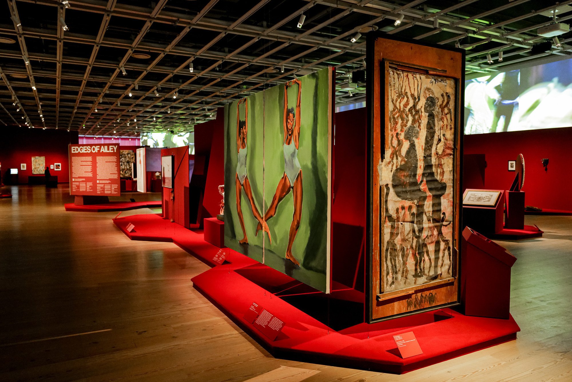 installation view of artwork featuring dancers in various poses