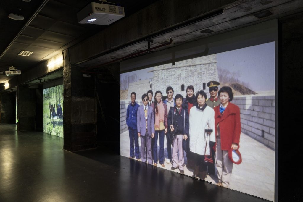 A projection of an archive photo depicting a group of people in china