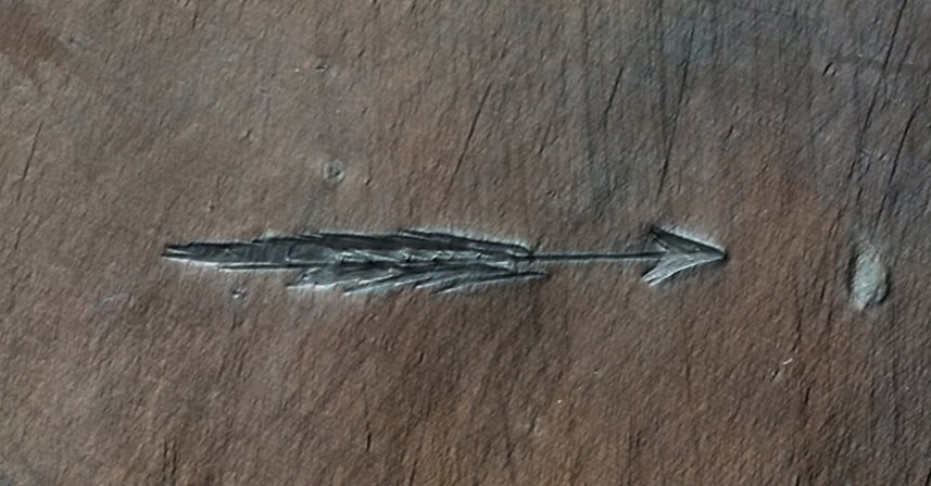 a copper plate showing an arrow marked in the center