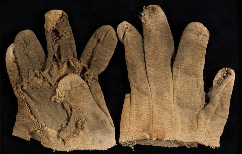 A pair of worn looking brown gloves worn in The Wizard of Oz (MGM, 1939) by Bert Lahr as the Cowardly Lion. 