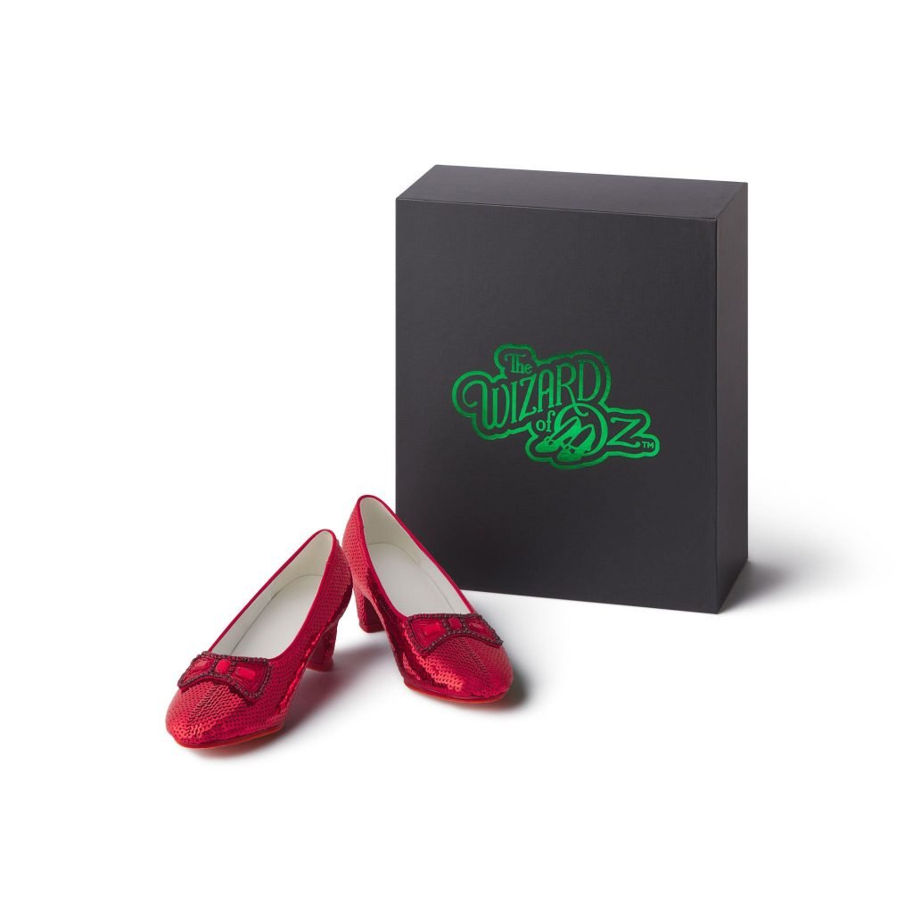 A pair of red sequin shoes next to a box with the label "The Wizard of Oz"