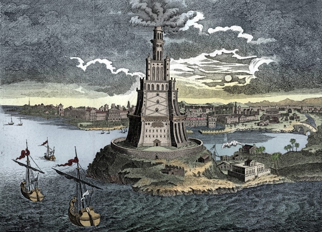 Colorful depiction of the Lighthouse of Alexandria, towering over the coastline with ships sailing below.