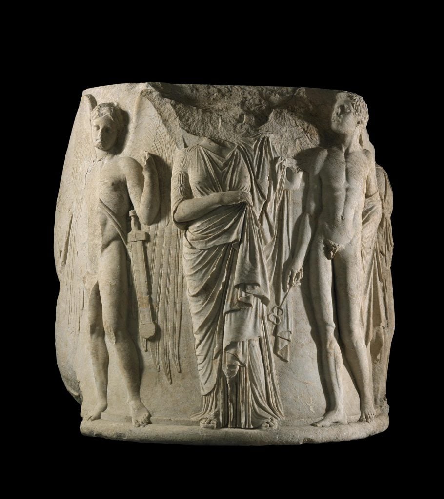 Ancient Greek marble column carved with various figures