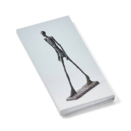 A chocolate bar with a sculpture of a walking man