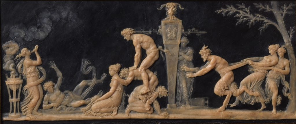 A wax relief sculpture with a number of nude figures playing leapfrog