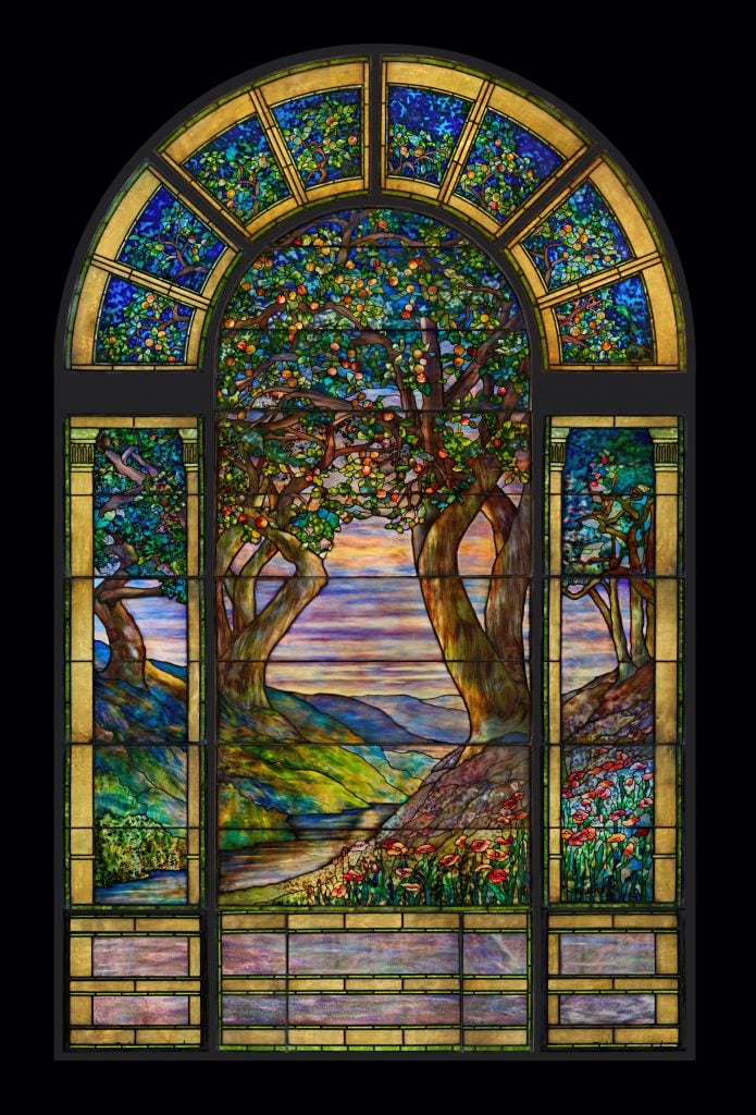 the full stained glass window showing trees, river, sky