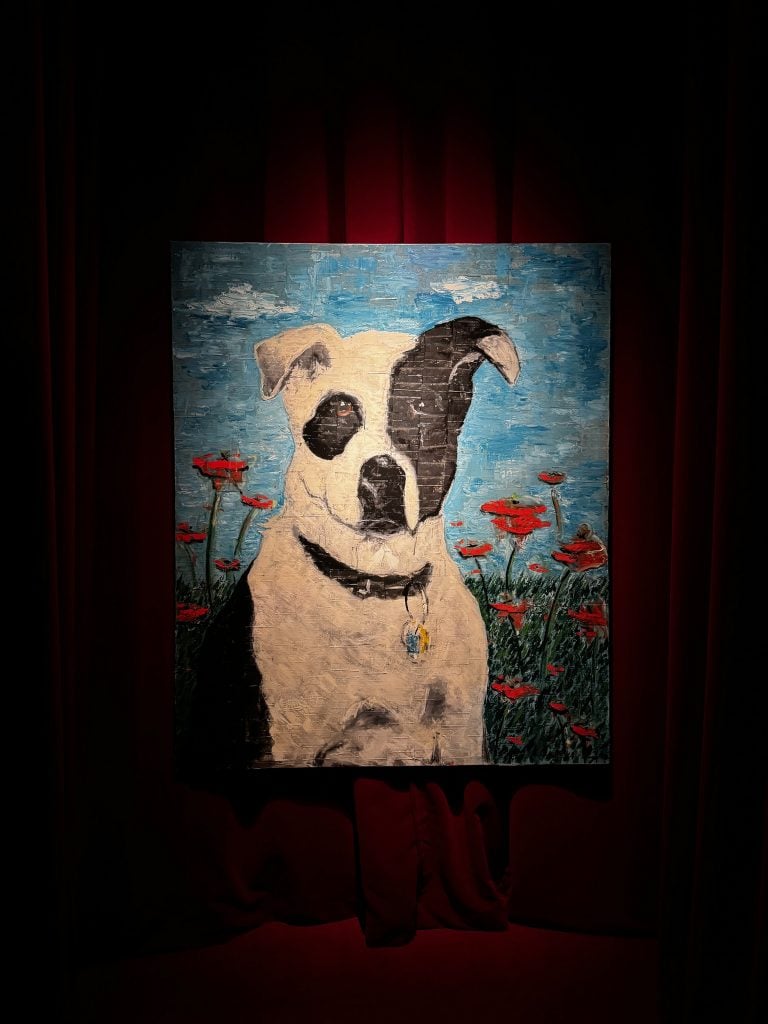 A painting by Johnny Depp of a dog sitting in a field of red flowers