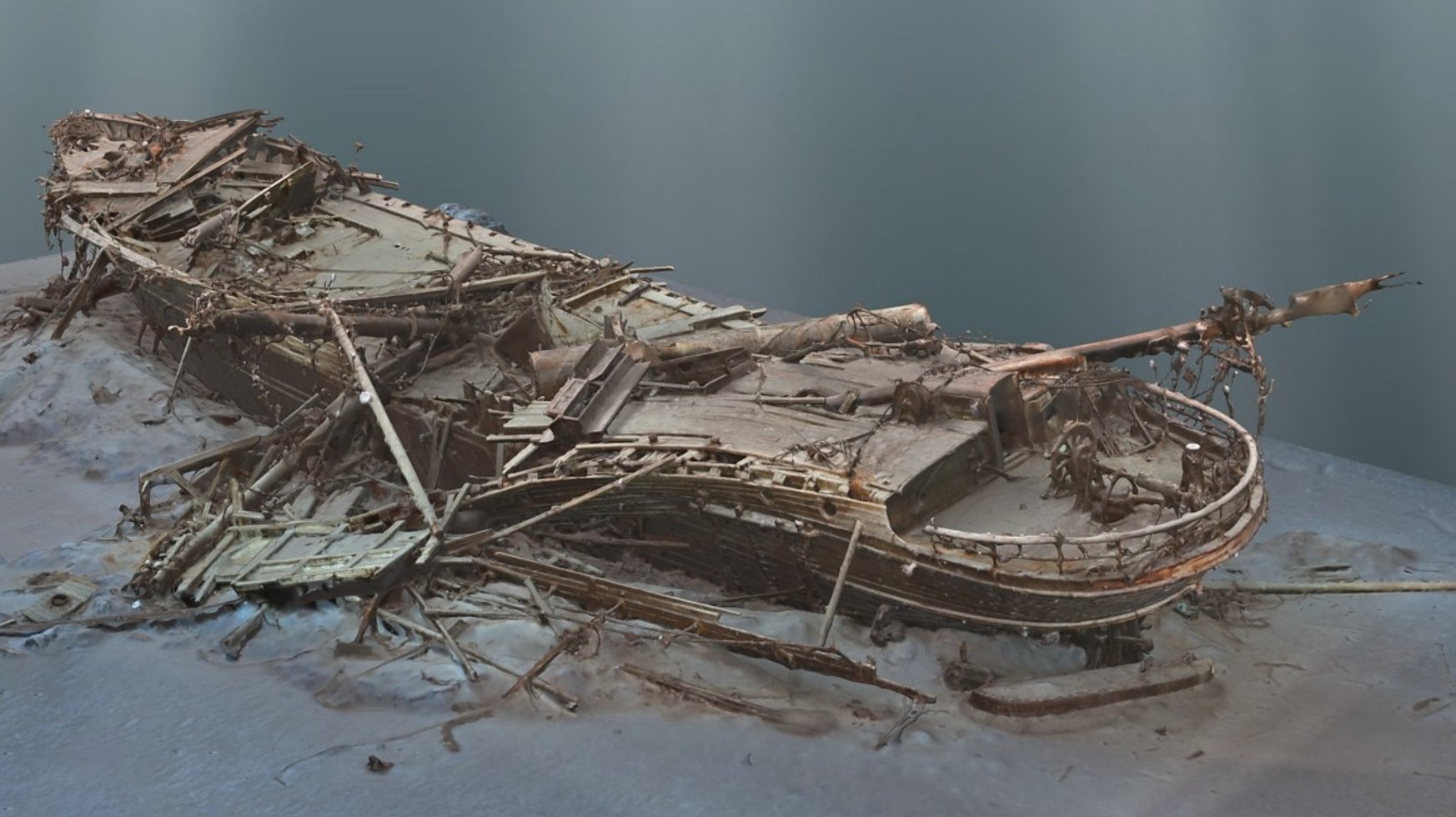 photo of a partially decayed wooden ship with broken masts and oars resting at the bottom of the sea