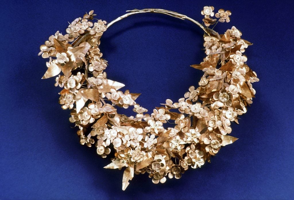 A funerary wreath made up of gold petals