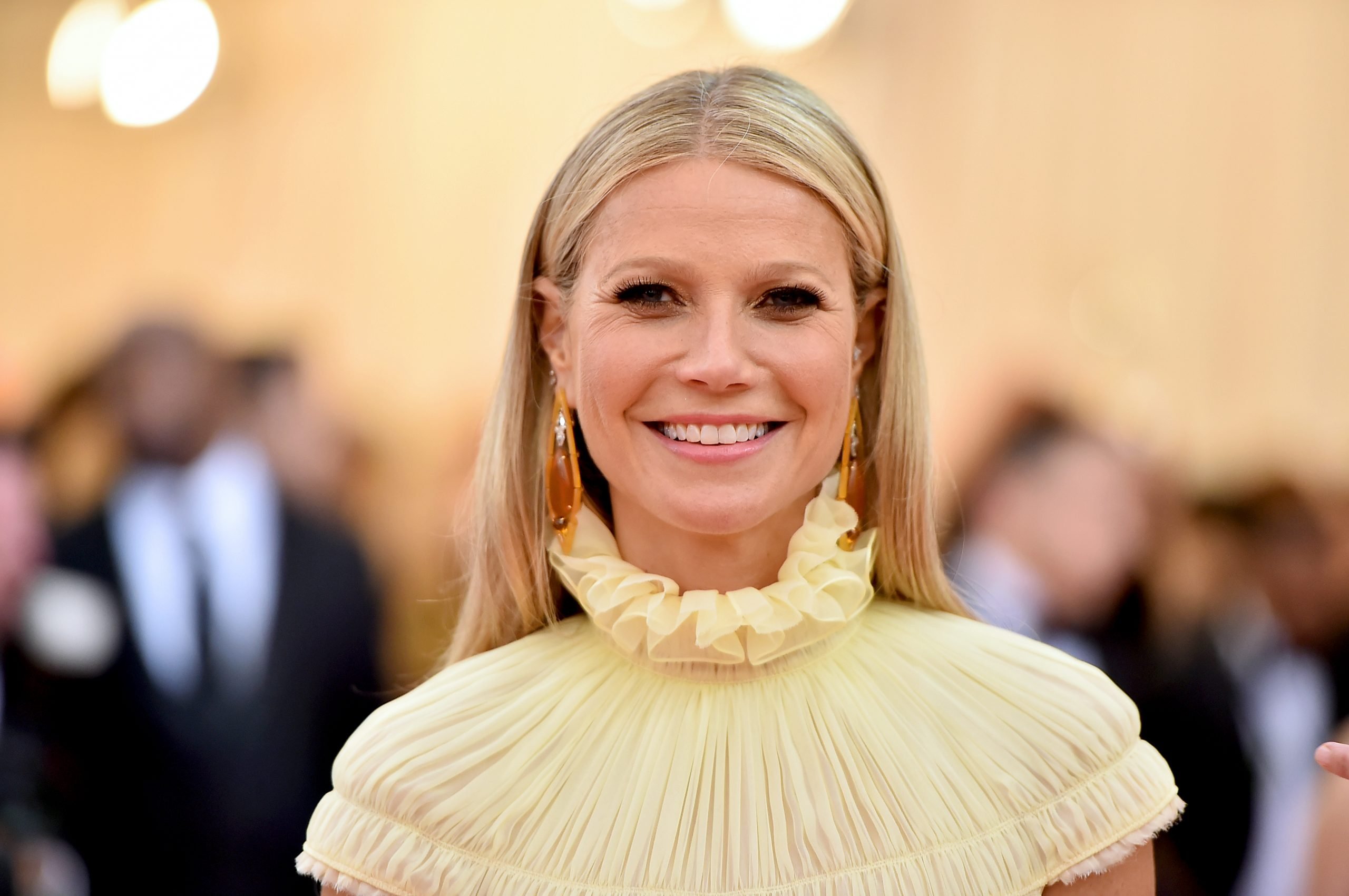 blonde woman in a ruffled pale yellow dress